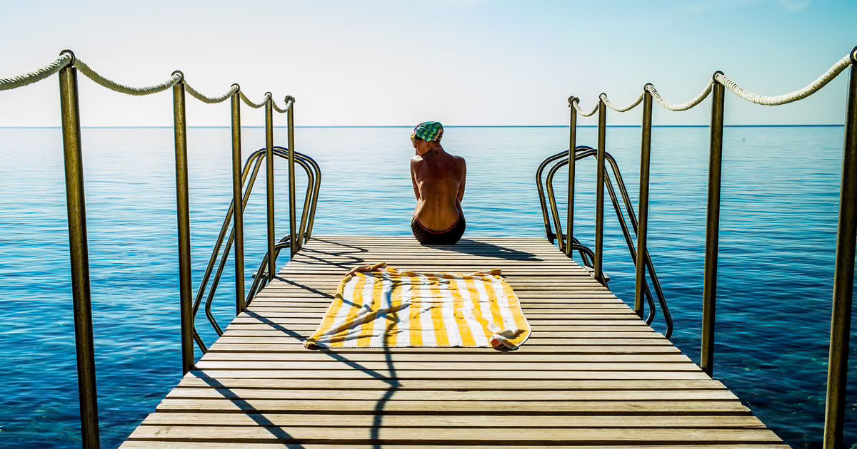 Woman with sunglasses walking down runway